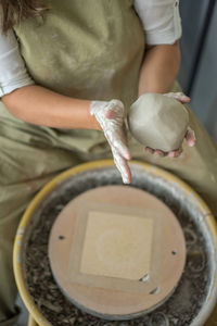 Woman making pottery on the wheel