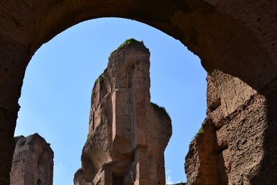 Low angle view of rock formation against clear sky