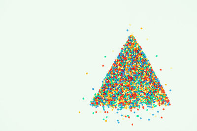 Multi colored christmas tree against white background