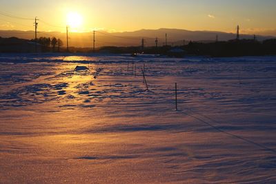 Scenic view of snowy field against sky during sunset at miyota