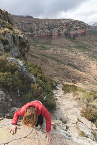High angle view of hiker climbing cliff at golden gate highlands national park