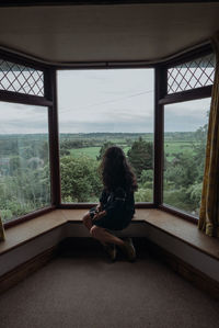 Woman looking through window