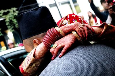 Close-up of bride embracing bridegroom during wedding ceremony