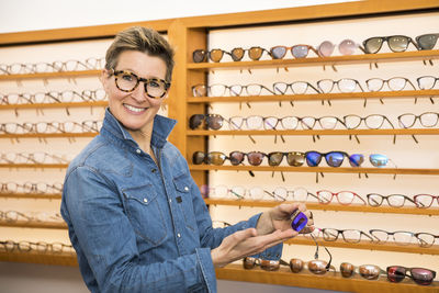 Portrait of smiling woman standing in store