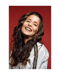 Portrait of a smiling young woman over white background