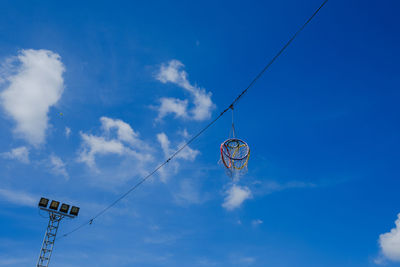 Low angle view of telephone pole against blue sky