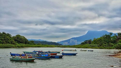 Boats moored in sea against sky