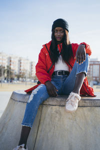 Portrait of young woman sitting outdoors