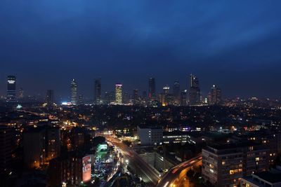 Illuminated cityscape against sky at night