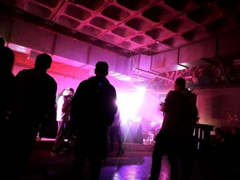 Silhouette people at illuminated nightclub
