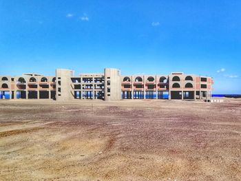 Built structure on beach against clear blue sky