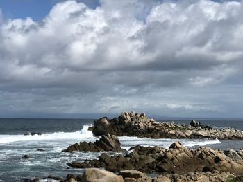 Rocks on beach against sky