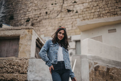 Full length of woman standing against building