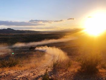 Scenic view of land against sky during sunset