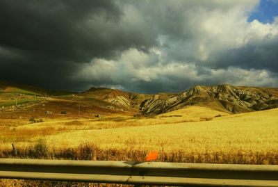 Scenic view of landscape against cloudy sky