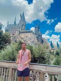 Portrait of young man standing in front of hogwarts universal studios 