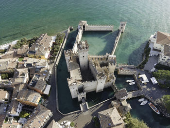 High angle view of old buildings by sea