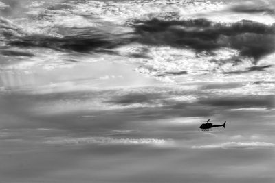 Low angle view of airplane flying against sky