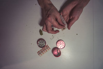 High angle view of hand holding ring on table