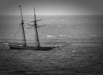 Sailboat sailing on sea against sky