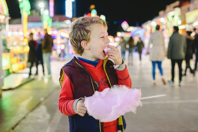 Cute boy eating cotton candy