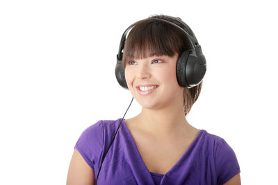 Portrait of a smiling young woman against white background