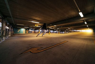 Rear view of person levitating in parking lot