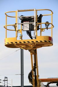 Low angle view of old machinery against sky