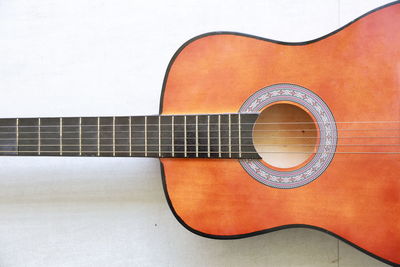 High angle view of guitar against white background