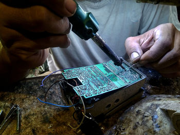 Midsection of technician working at workshop