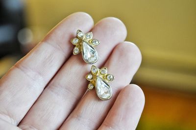 Close-up of hand holding earrings