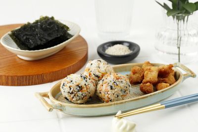 Korean seaweed rice balls or jumeokbap with ham, sausage, sesame seed, sesame oil, and carrots