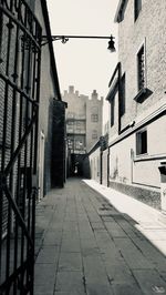 Empty alley amidst buildings in city