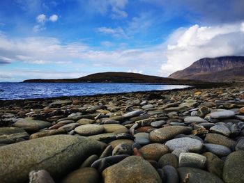 Rocks on beach against sky