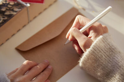 Cropped hand of woman using mobile phone