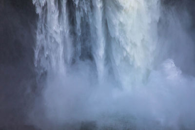 Scenic view of waterfall against sky