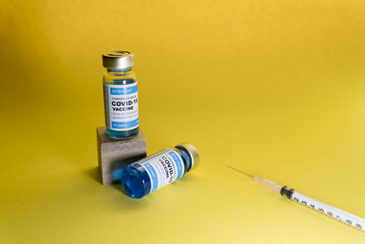 Close-up of bottle against yellow background