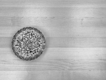 Crystal ashtray full of cigarette butts in black and white