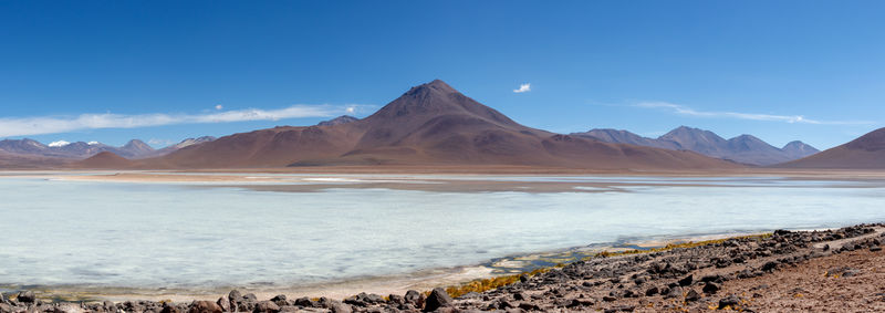 Scenic view of sea and mountains against sky