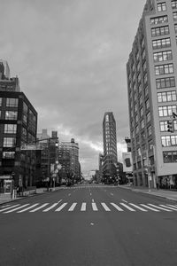 City street and buildings against sky