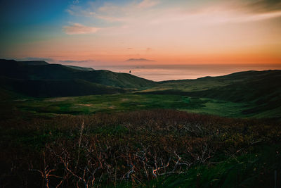 Scenic view of landscape against sky during sunset