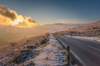 Scenic view of road against sky during sunset