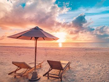 Scenic view of beach against sky during sunset