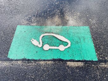 High angle view of arrow sign on road