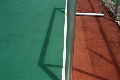 High angle view of a goal post and its shadow