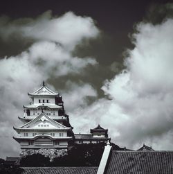 Low angle view of built structure against cloudy sky