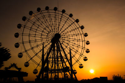 Low angle view of silhouetted ferris wheel