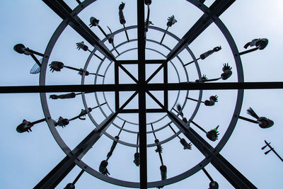 Low angle view of clock against sky