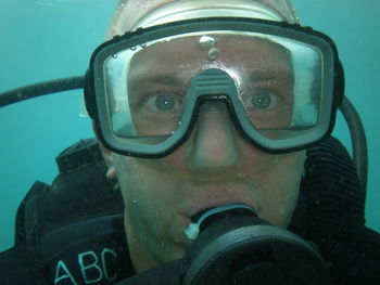 Close-up portrait of man scuba diving in sea