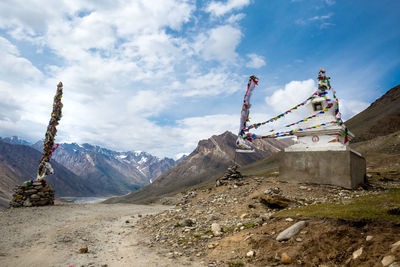 Traditional windmill on mountain against sky